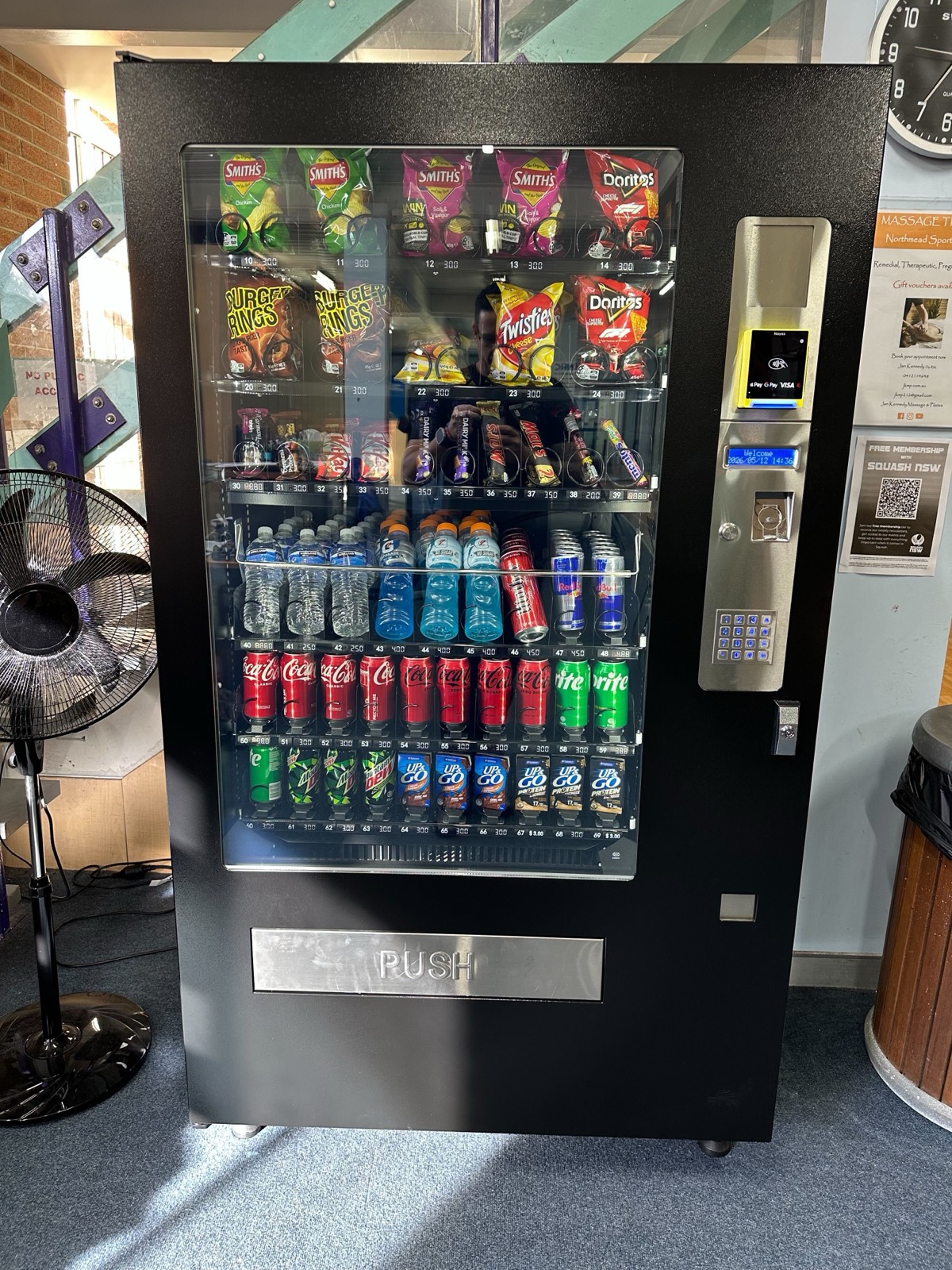 An AKRA vending machine fully stocked with drinks and snacks